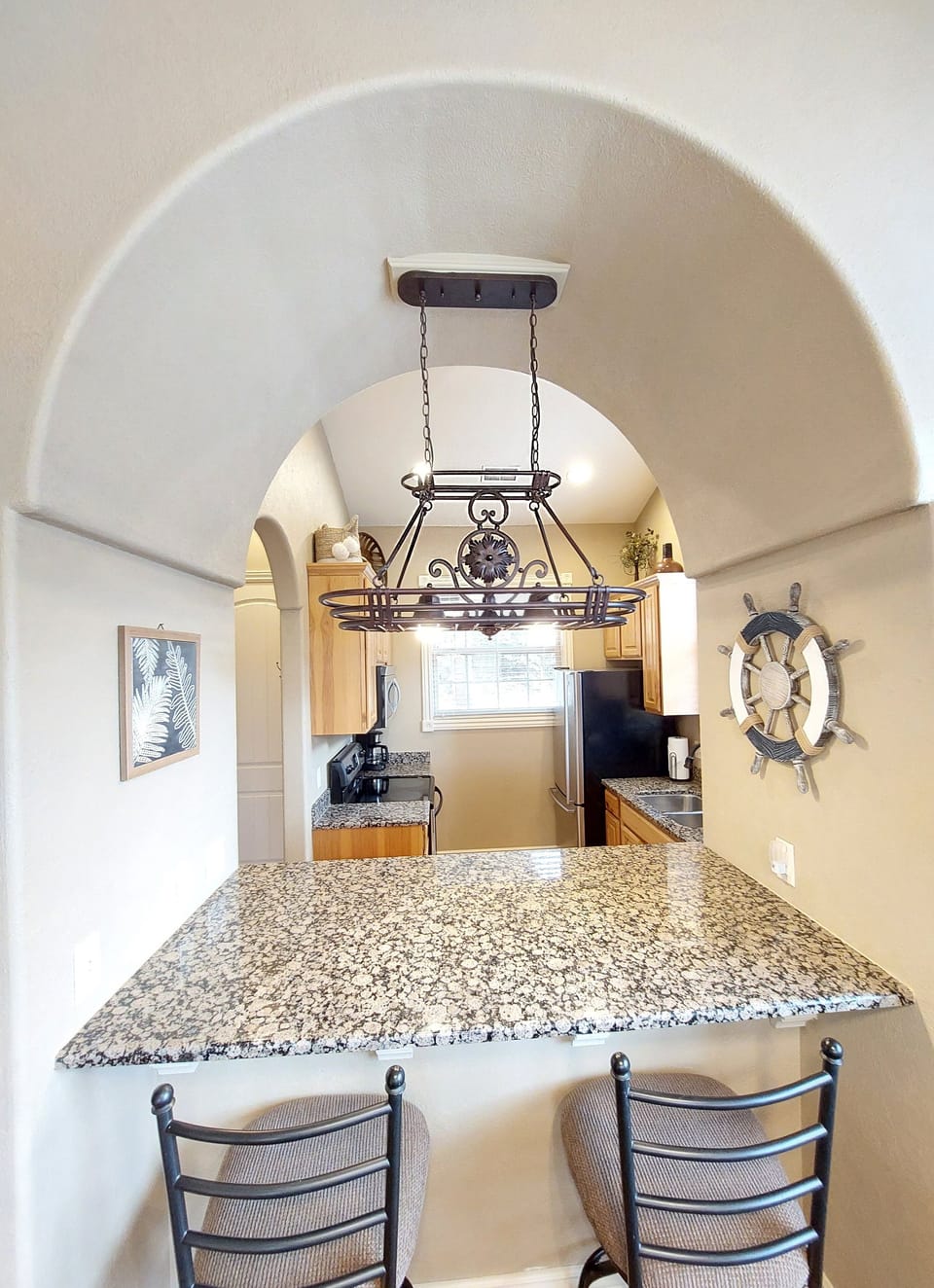Breakfast bar, tall chairs, gorgeous lighting and decor!