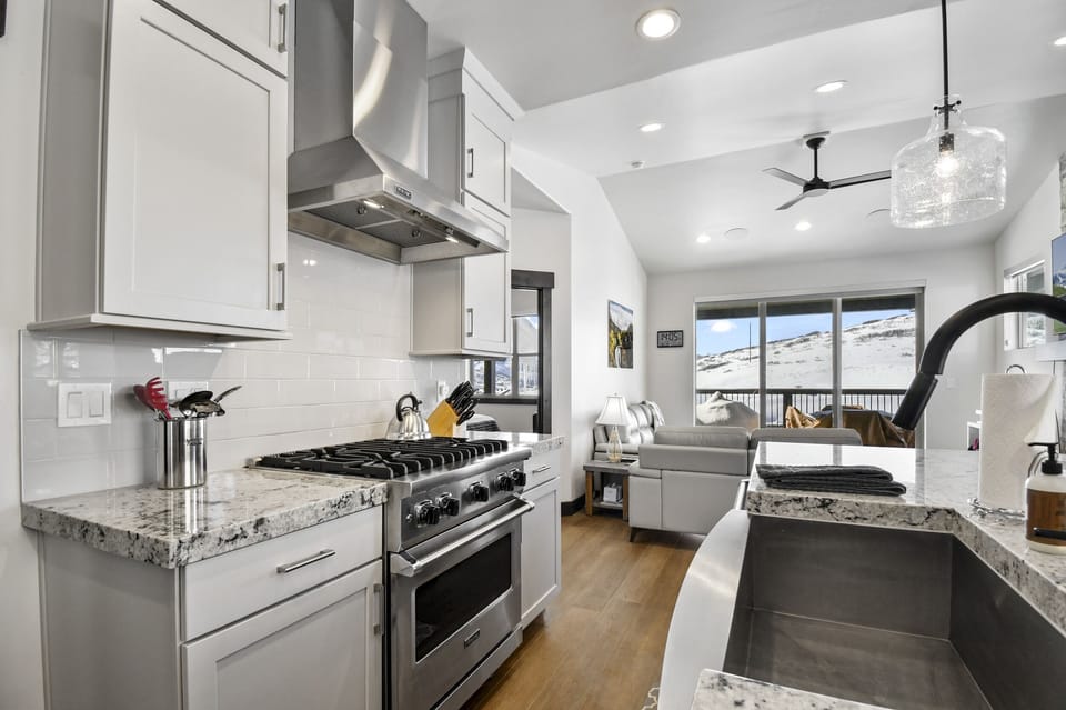 Cook with ease in this modern kitchen featuring high-end appliances, generous counter space, and an open layout.
