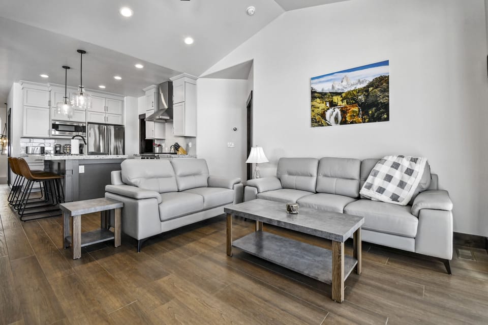The spacious living room seamlessly connects to the kitchen and dining areas, creating the perfect gathering space.