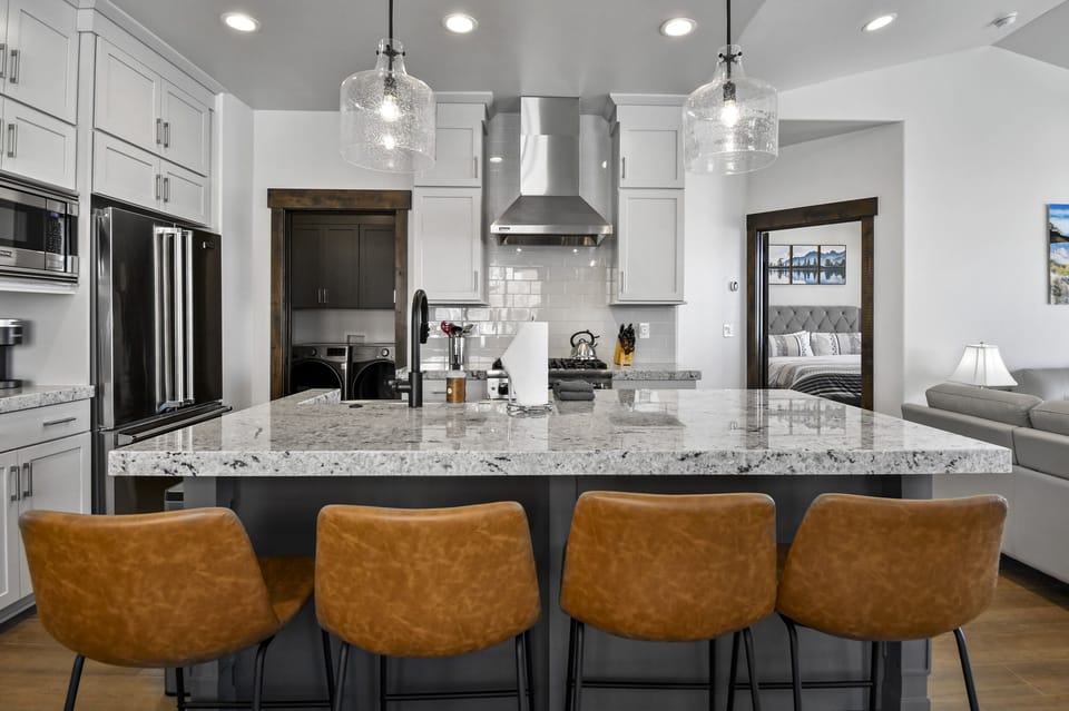 The oversized kitchen island offers additional seating, making it the perfect spot for breakfast, snacks, or evening conversations.