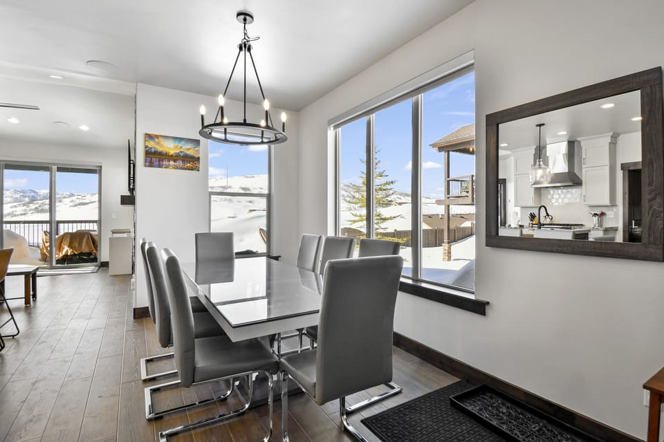 Enjoy memorable meals together at the dining table with seating for eight, perfectly positioned beside expansive mountain-view windows.
