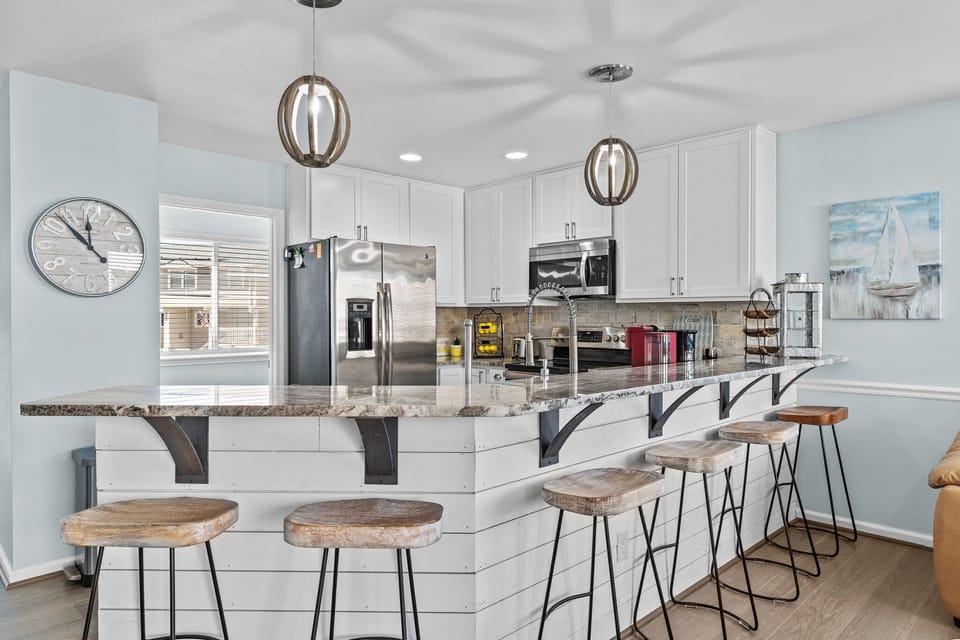 Your spacious kitchen invites culinary adventures with granite counters, stainless appliances, and stylish seating for memorable meal prep.
