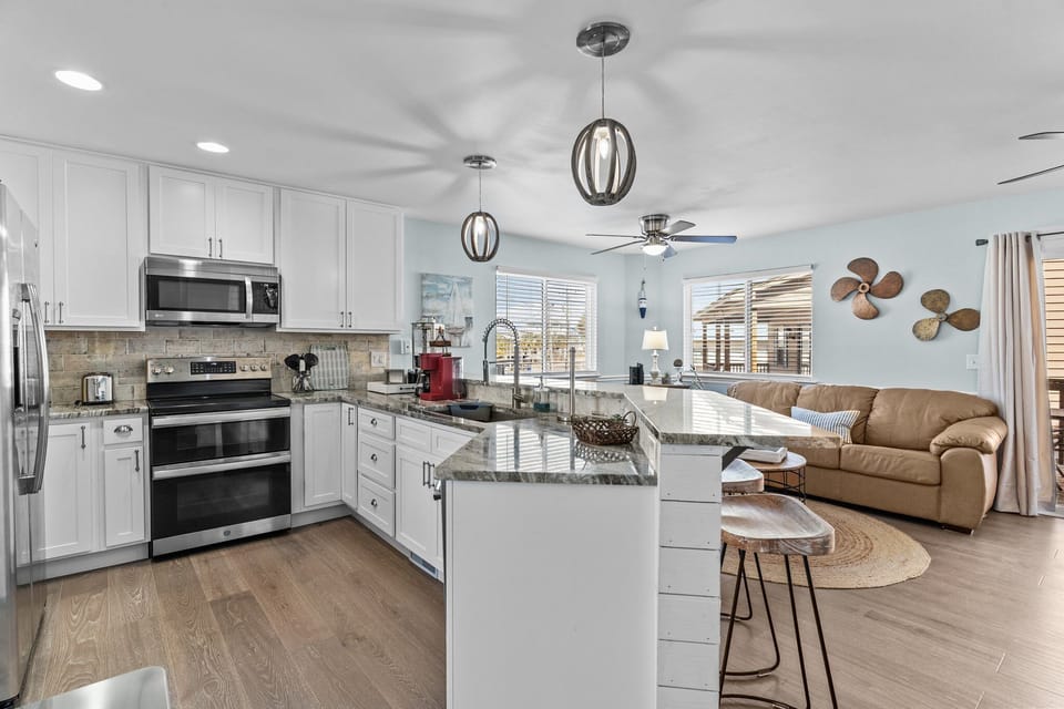 Cook memorable meals in your fully equipped kitchen with granite counters and modern appliances, then unwind in the cozy living area.