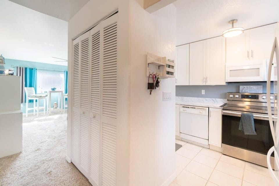 Bright kitchen with stainless steel appliances and adjacent dining area.