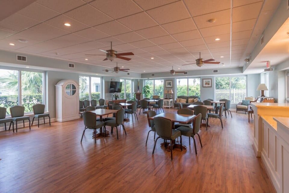 Spacious community room with natural light and seating for group activities.