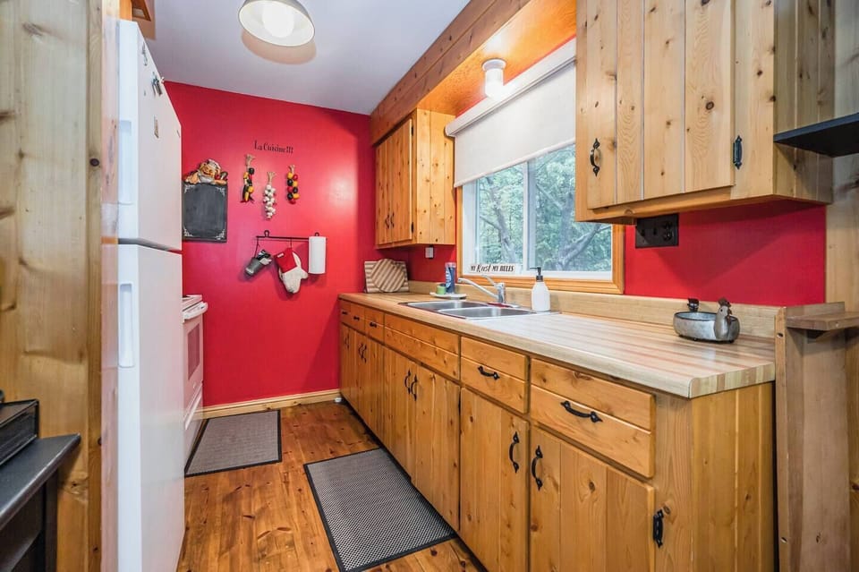 The cozy galley kitchen is tucked away beside the dining space.
