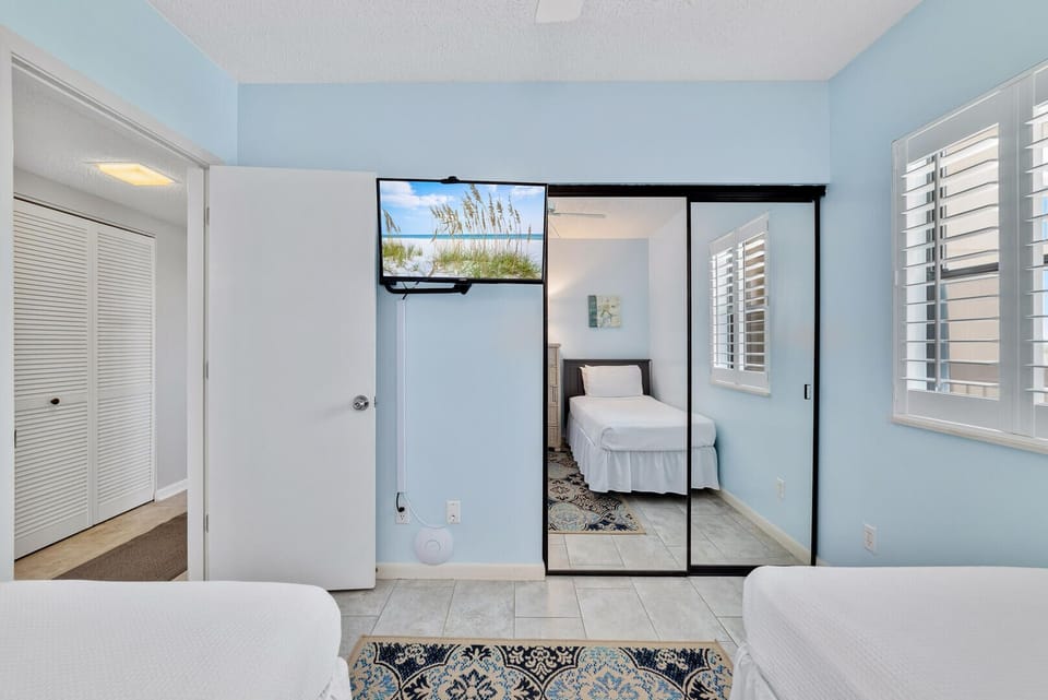 The Smart TV offers cable and streaming options for your entertainment. The double mirrored doors of the closet provide convenient dressing space for both guests.