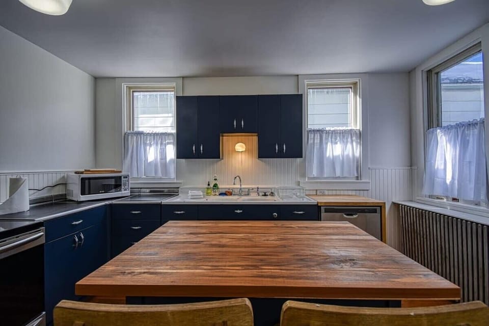 【Kitchen — Island】 Butcher-block island with table seating for 4 — open to living room for easy conversation.