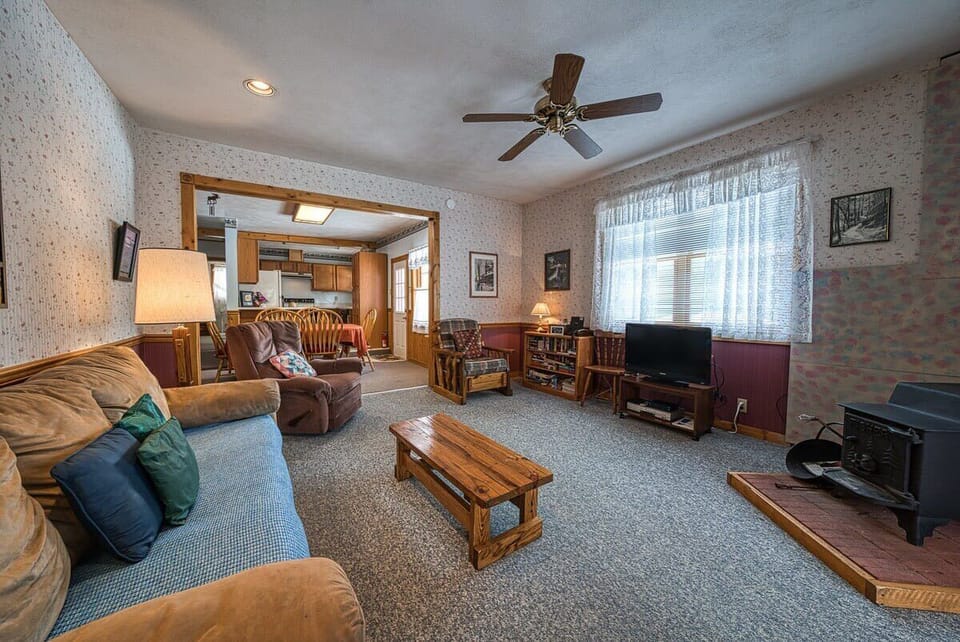【Living Room】Sawatch light through the front windows; seating by the wood stove