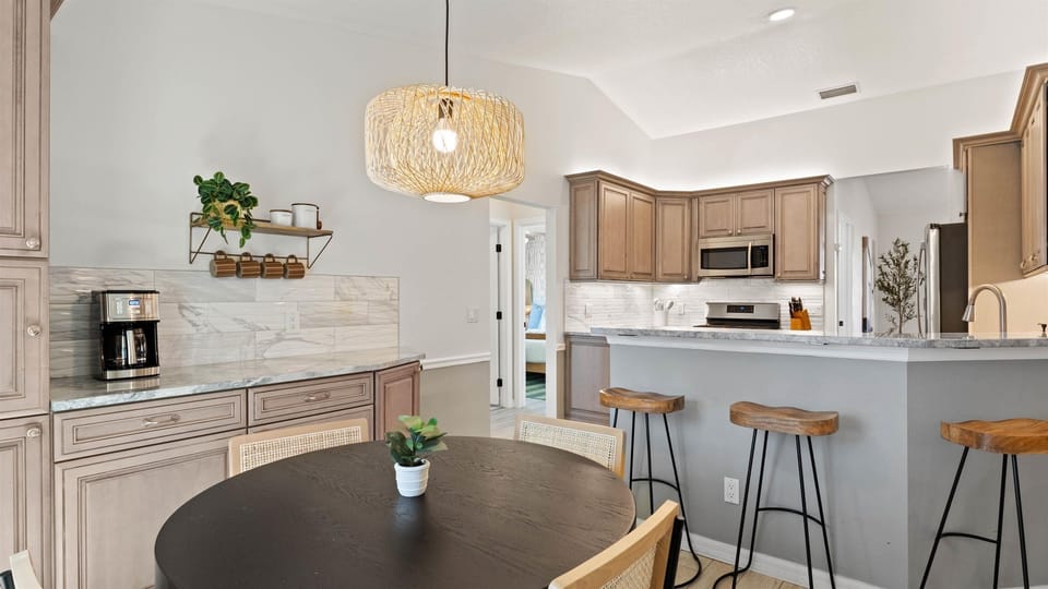 Enjoy a chef’s kitchen with full amenities, an inviting island bar, and a dedicated dining area for intimate meals.”