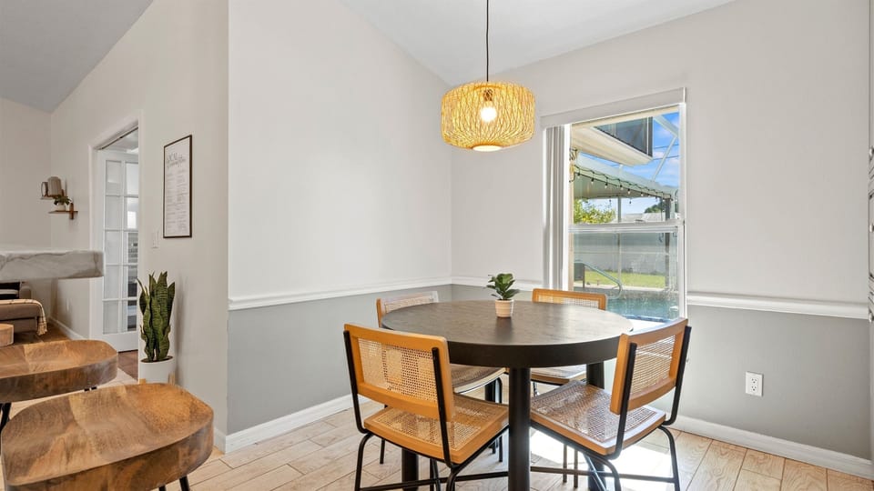 Spacious kitchen with island seating for 3 and a separate dining table for 4 — perfect for casual breakfasts or elegant dinners.