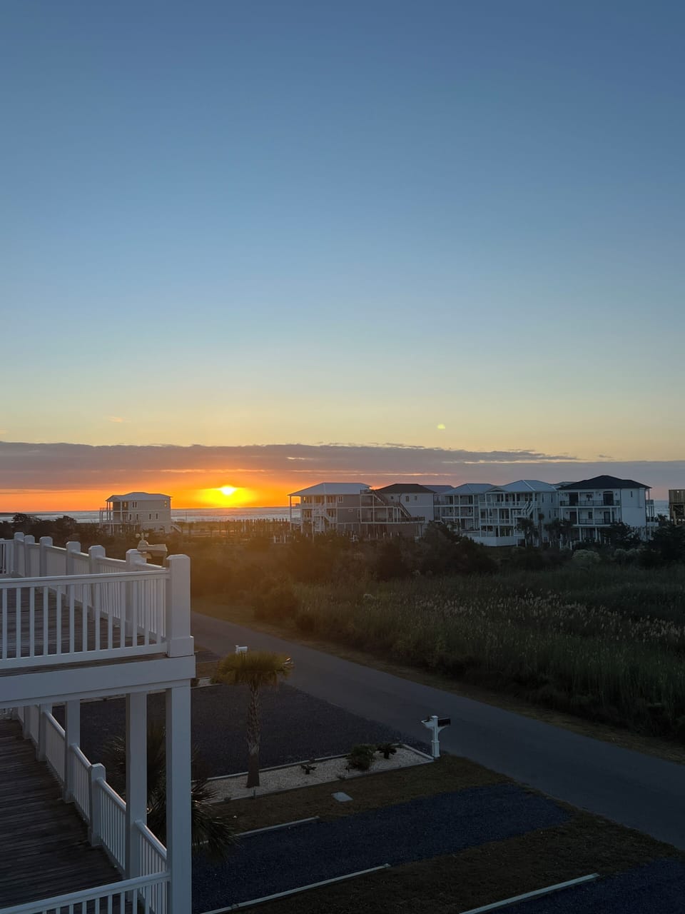 Sunrise from front upper level deck accessed by primary bedroom and queen bedroom