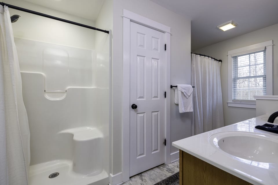 Master bathroom has a double sink vanity, a standup shower and a bathtub/shower.