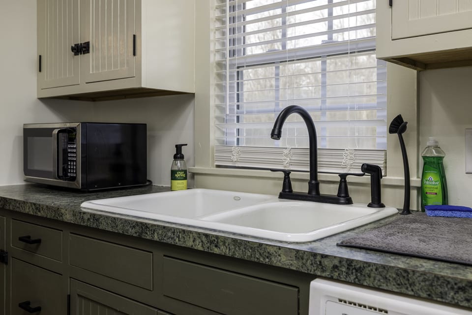 Kitchen with freshly painted cabinets and new hardware.
