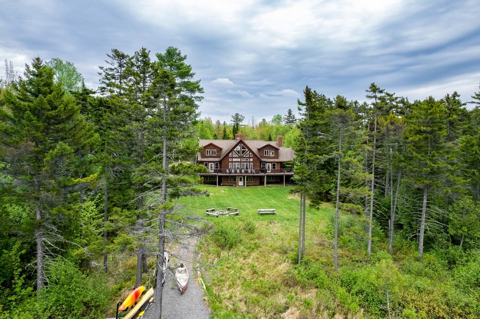 Escape to the back yard overlooking beautiful Lily Bay with amazing sunsets. Play a game of corn hole, gather by a crackling fire with 2 fire pits, use 2 kayaks and 2 paddle boards, or lounge by the your private dock and read a book.