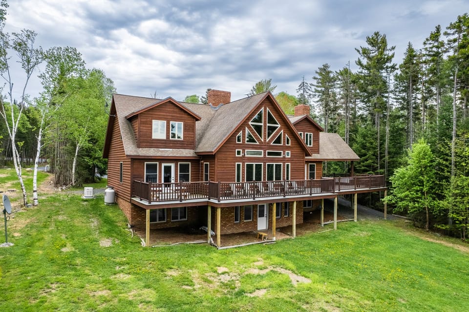 Escape to the back yard overlooking beautiful Lily Bay with amazing sunsets. Play a game of corn hole, gather by a crackling fire with 2 fire pits, or lounge by the your private dock and read a book. An enjoyable spot for everyone to hang out.