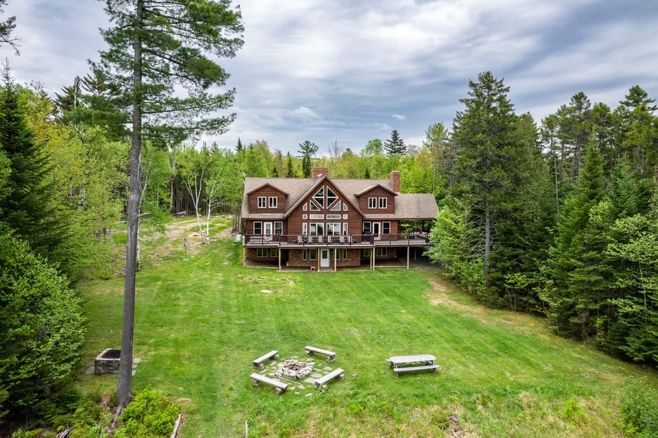 Escape to the back yard overlooking beautiful Lily Bay with amazing sunsets. Play a game of corn hole, gather by a crackling fire with 2 fire pits, or lounge by the your private dock and read a book. An enjoyable spot for everyone to hang out.