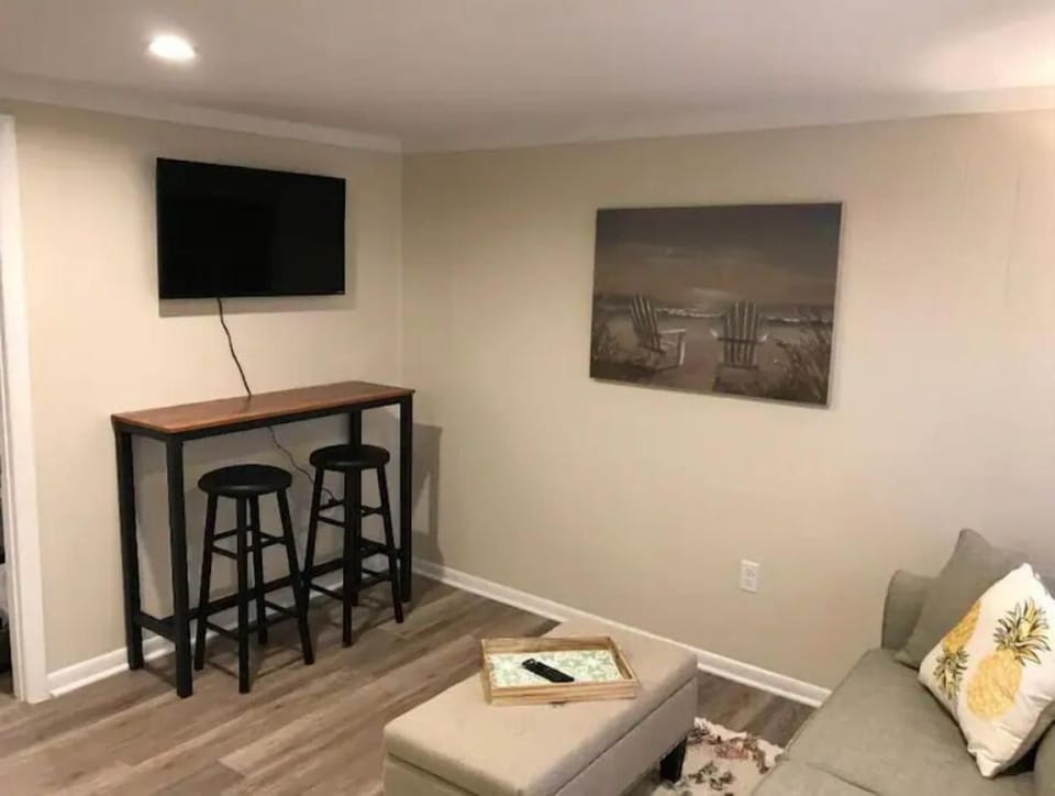 Open concept living room, kitchen and eating area and cable TV.