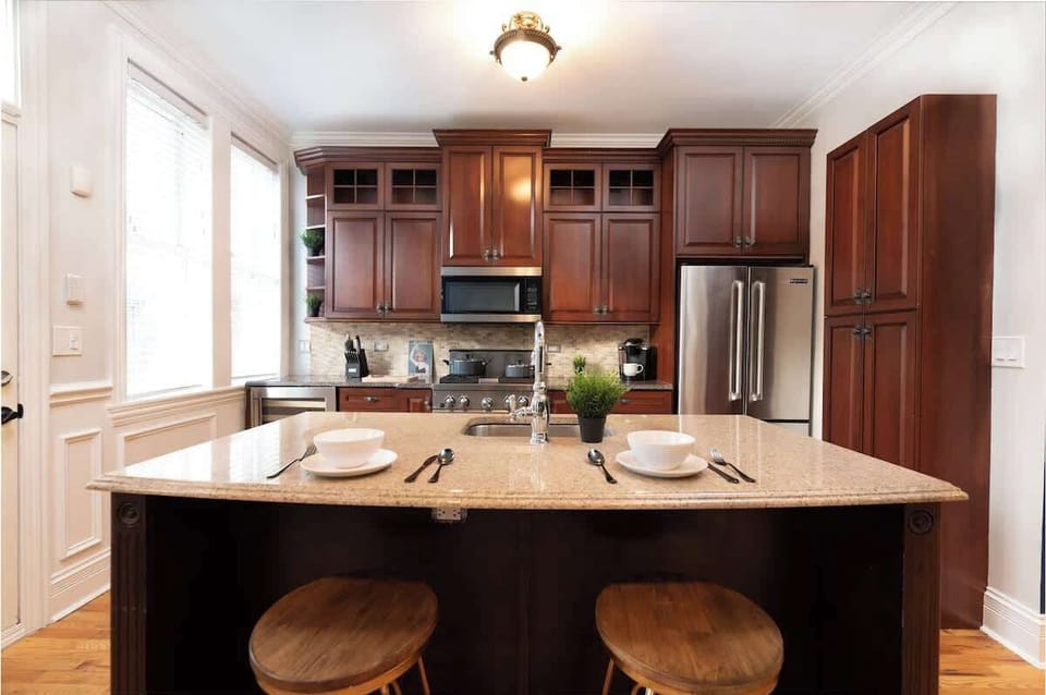 Breakfast bar with room for 3 or 4 stools. Wine fridge in kitchen and coffee station. 