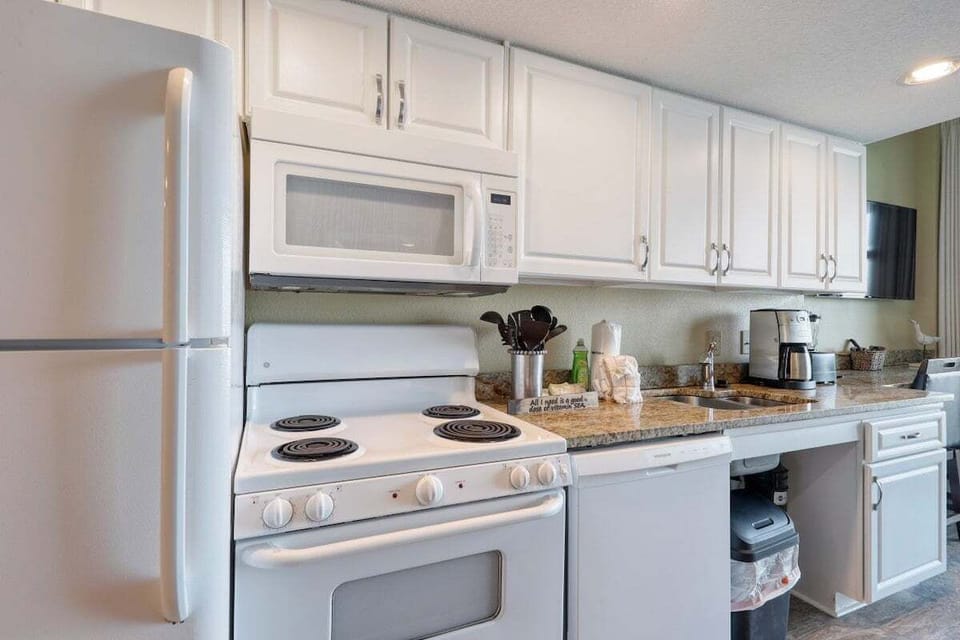 Kitchen: Culinary adventures await with modern appliances and sleek granite countertops!