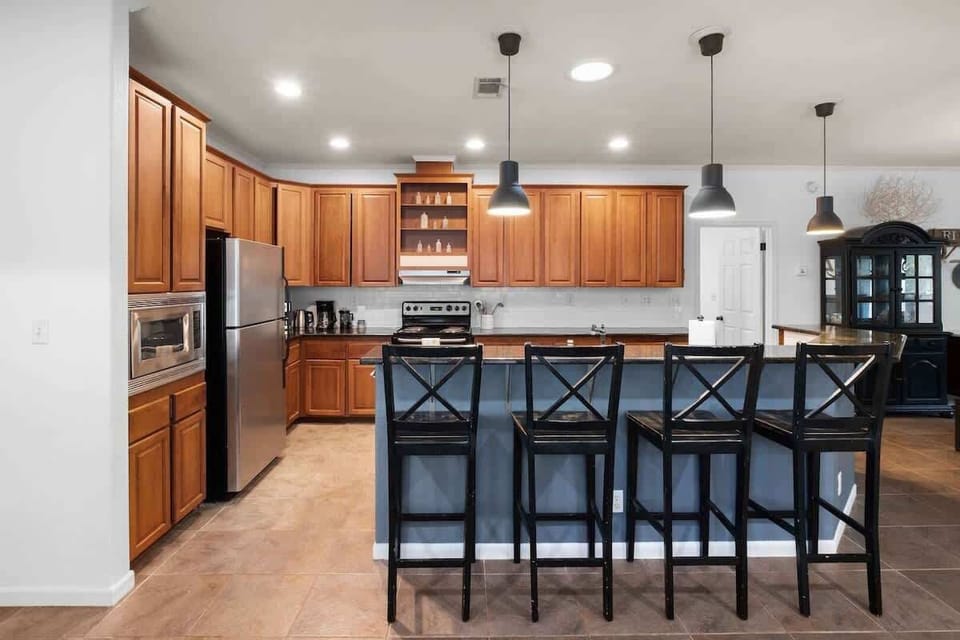 Kitchen area with island table and chairs