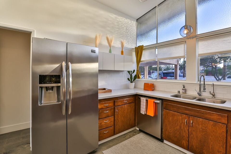 Full service kitchen with fridge, dishwasher, microwave, oven & cooktop.