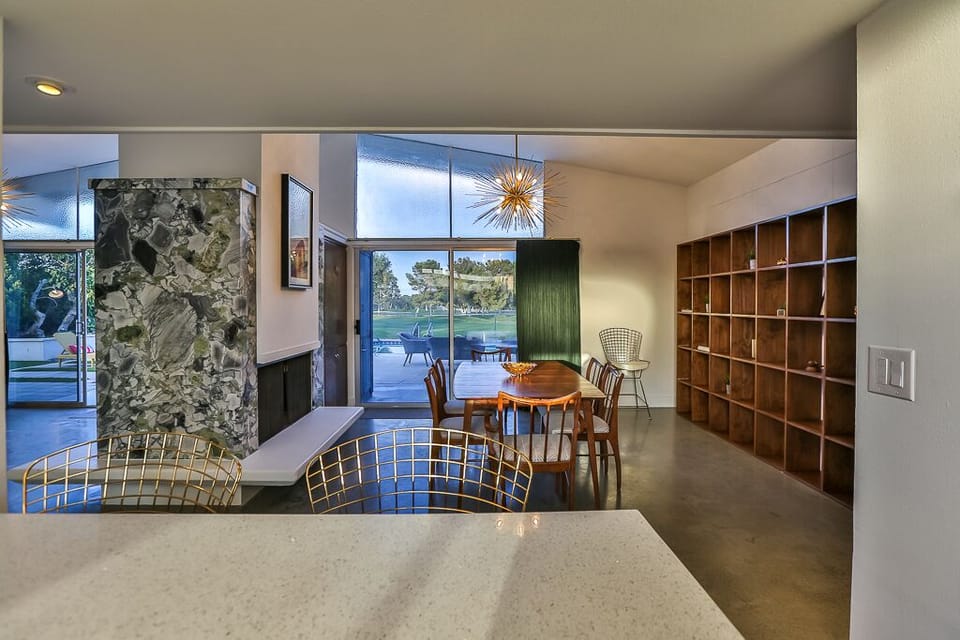 Kitchen looking into dining room and living room, both with golf course views.