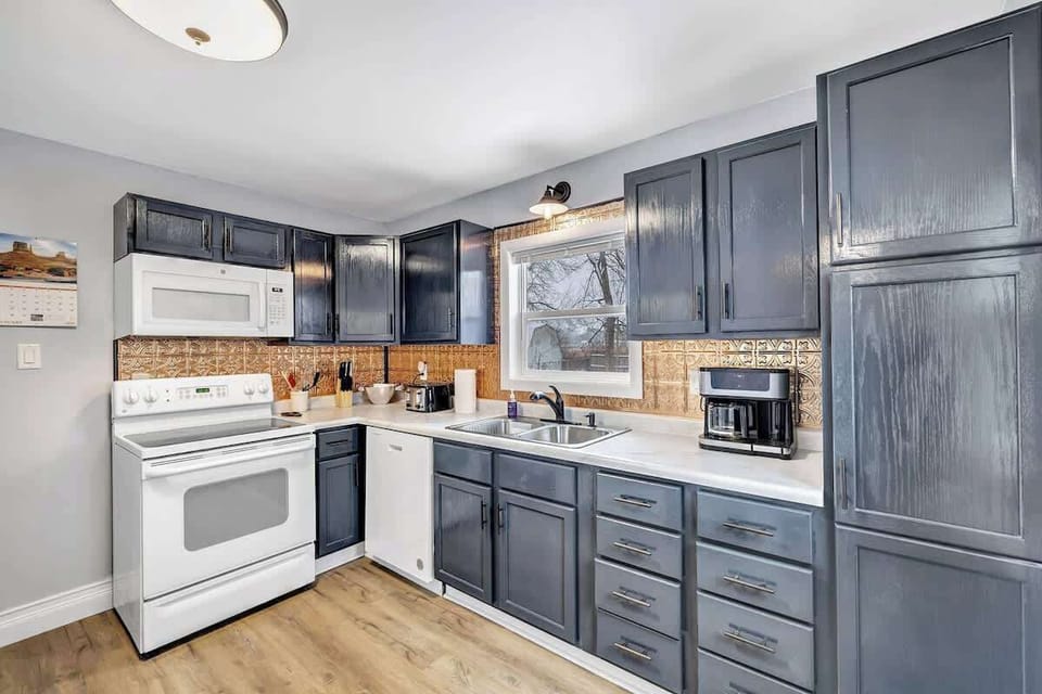 Fully equipped kitchen with pots/pans, utensils, cooking appliances