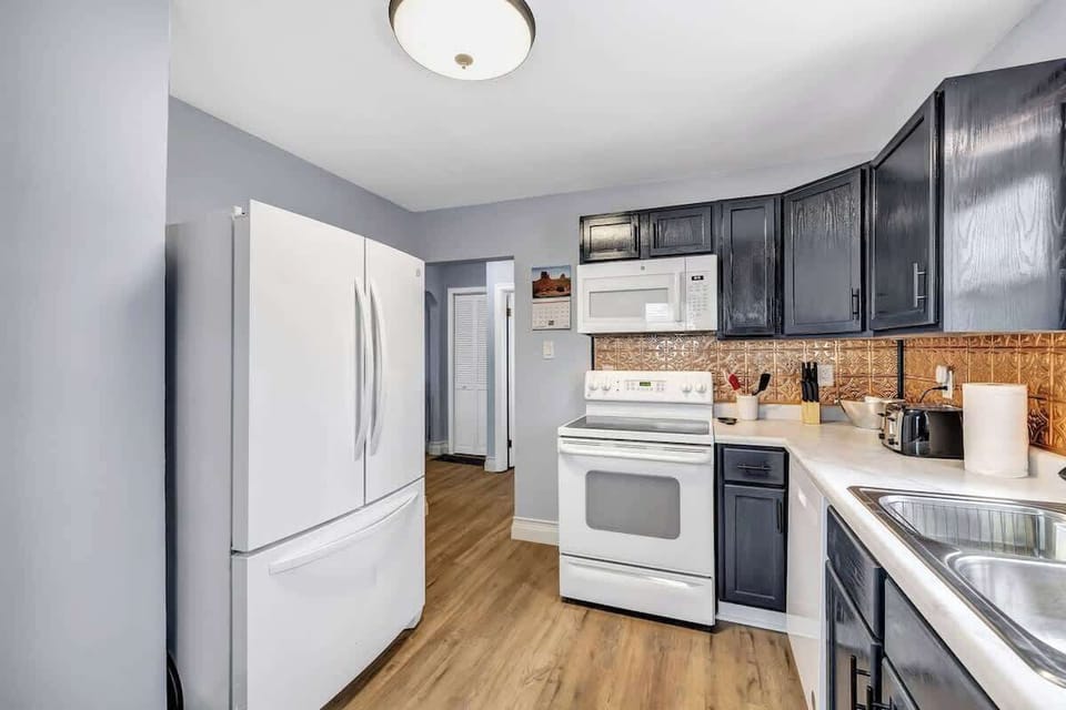 Fully equipped kitchen with pots/pans, utensils, cooking appliances