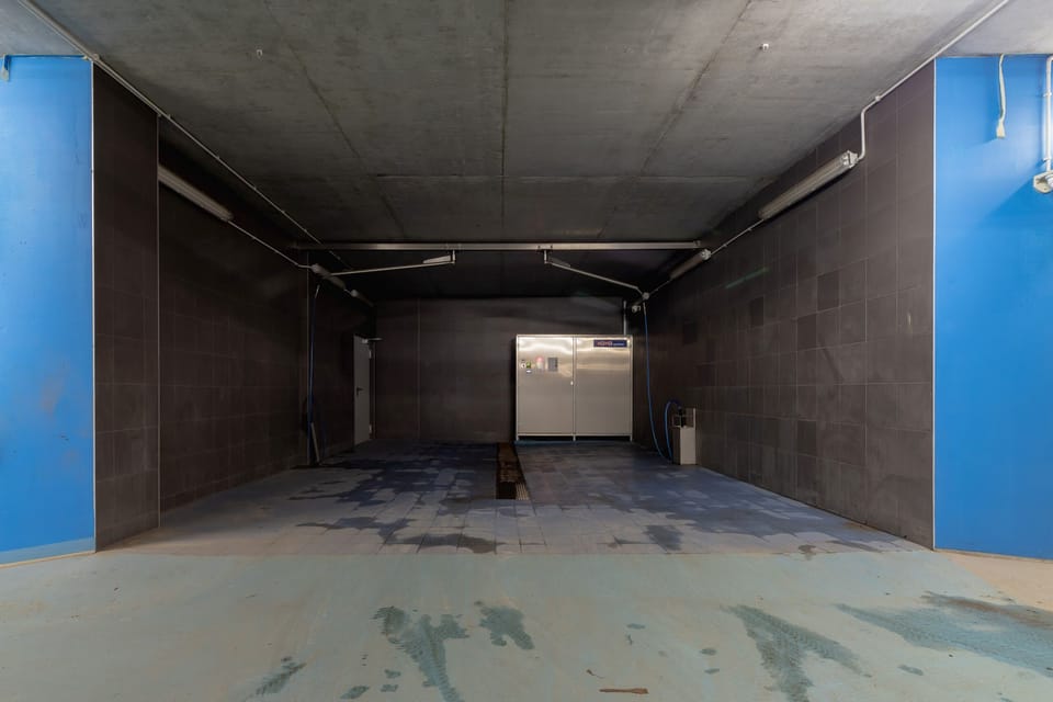 A car parking entrance with wide spaces and clean surroundings.
