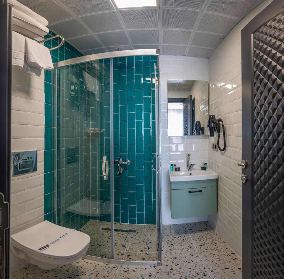 Shower, hair dryer, slippers, towels