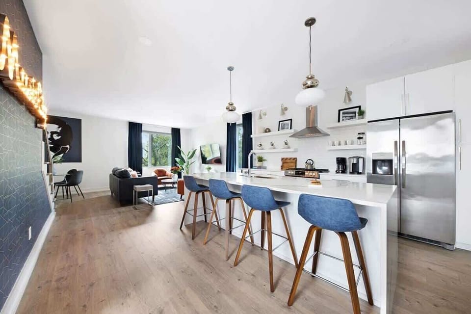 Clean and Spacious Kitchen with Sleek Countertops and Additional Seating
