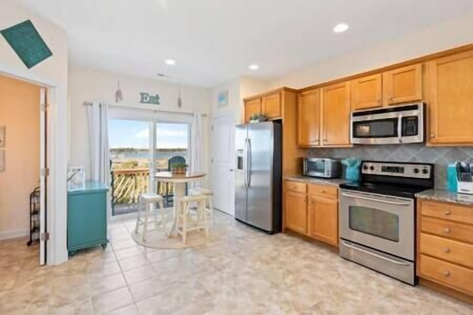 Kitchen has many pots, pans, utensils, etc. 