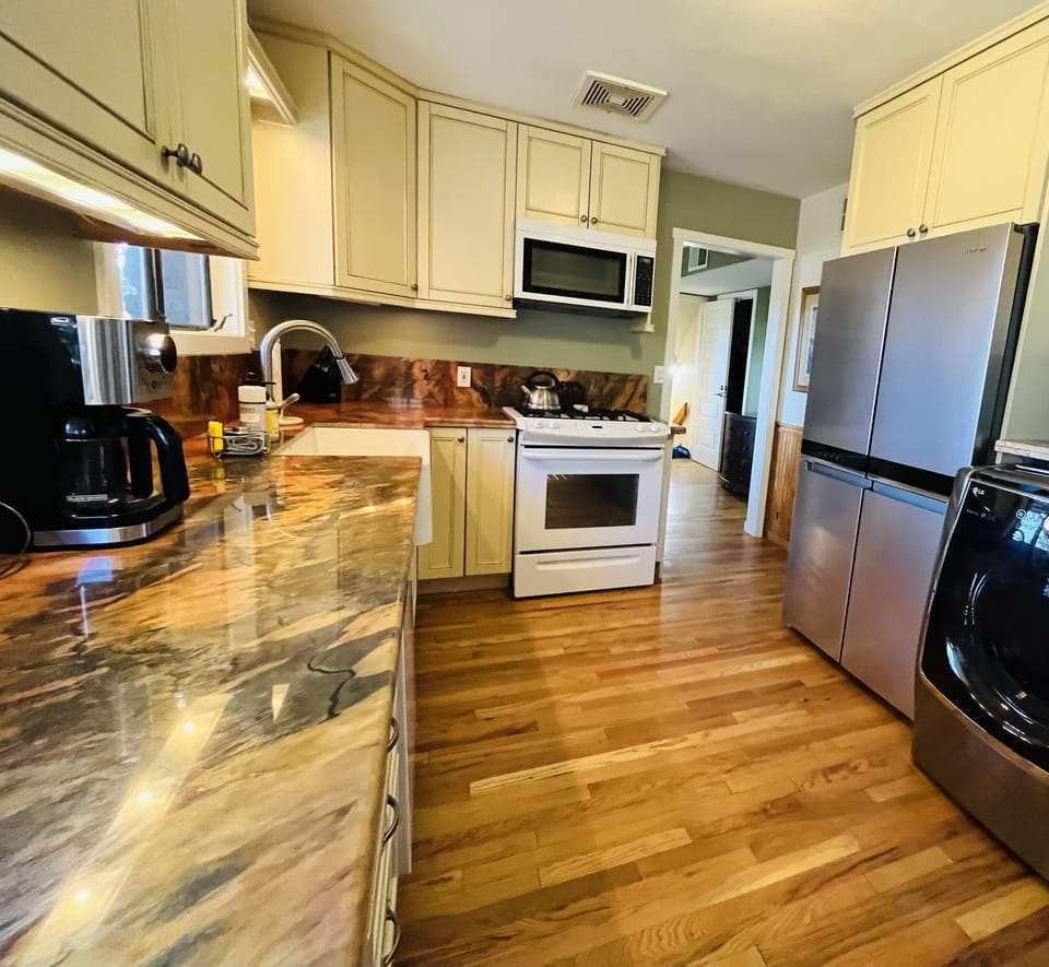 Fully stocked kitchen with gas range, microwave and toddler dishes.
