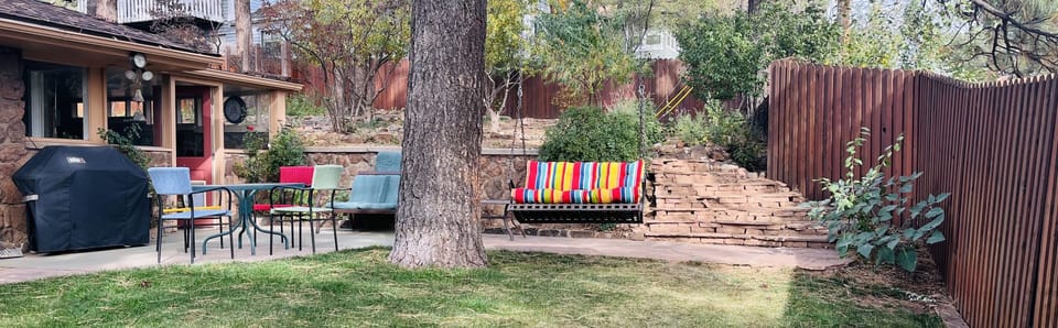 Spacious and securely fenced back yard with gas grill