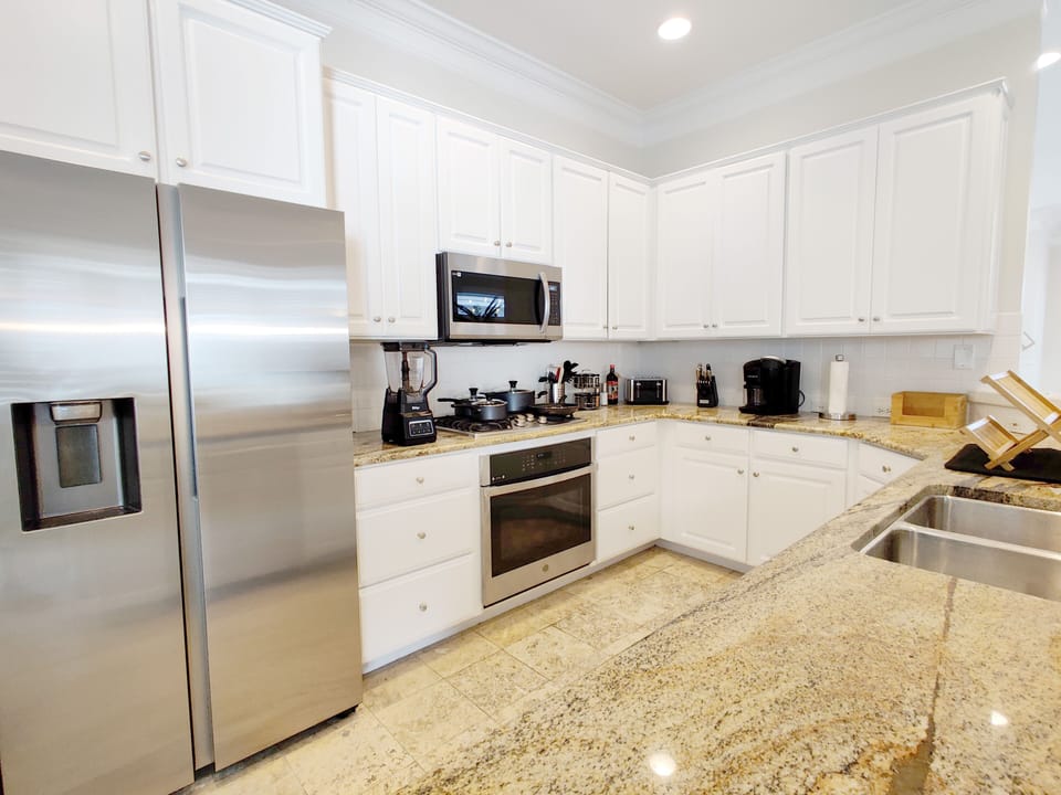 Fully equipped kitchen with stainless steel appliances and granite countertops