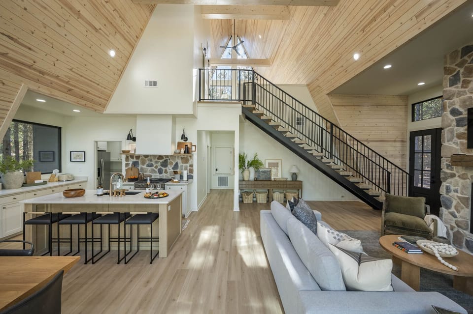 "Be captivated by the high ceilings and warm ambiance of our A-frame cabin, where every detail is a testament to craftsmanship."