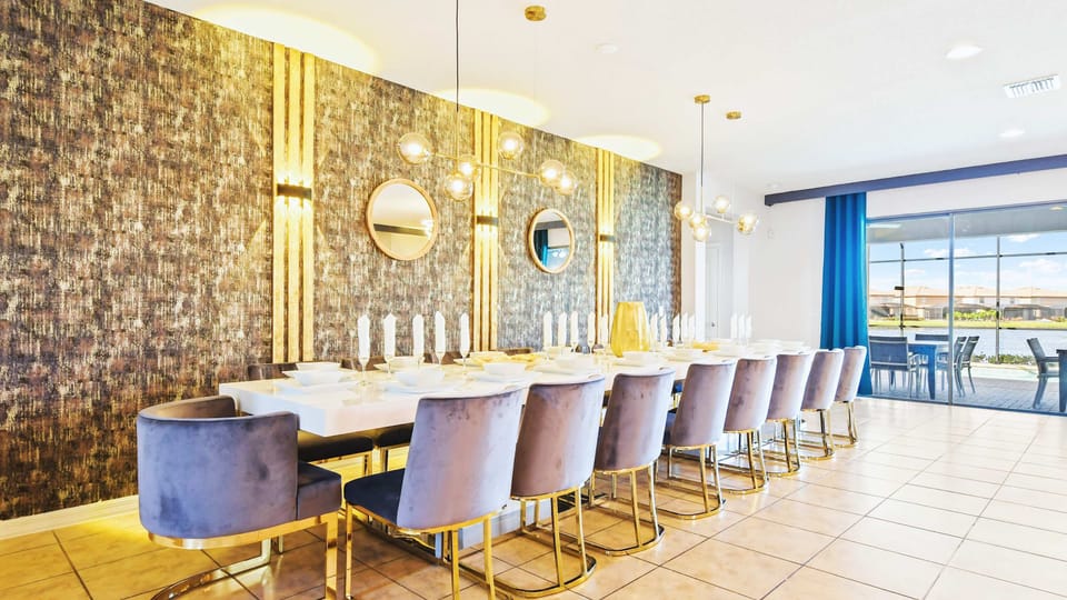 Stunning formal dining room with velvet seating, gold accents, and elegant lighting.
