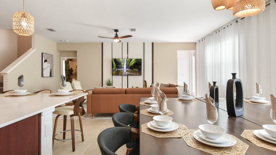 Open-concept living space with a modern dining area, stylish kitchen, and cozy seating.