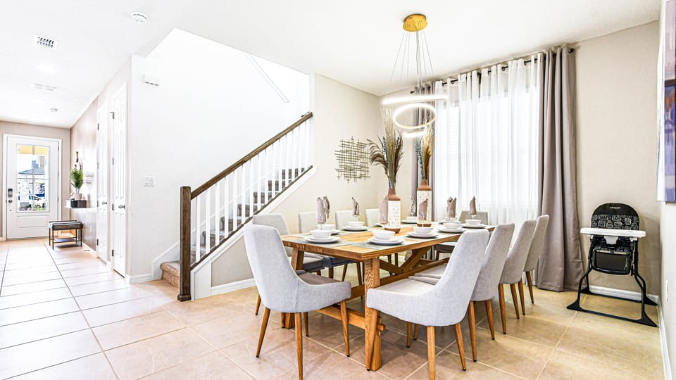 Chic dining room with elegant seating, modern lighting, and natural light.