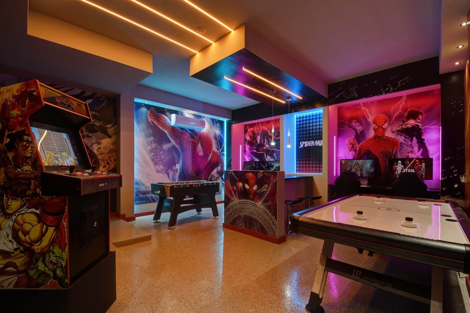 Superhero-themed arcade room with games and neon lights—fun for all ages!