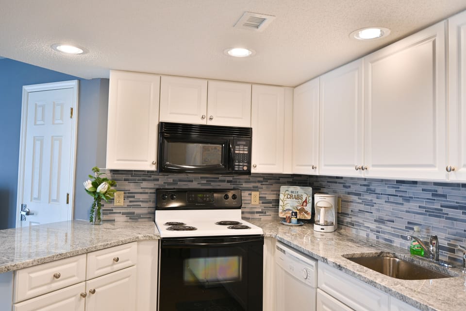 Fully equipped kitchen featuring modern appliances and clean counters.