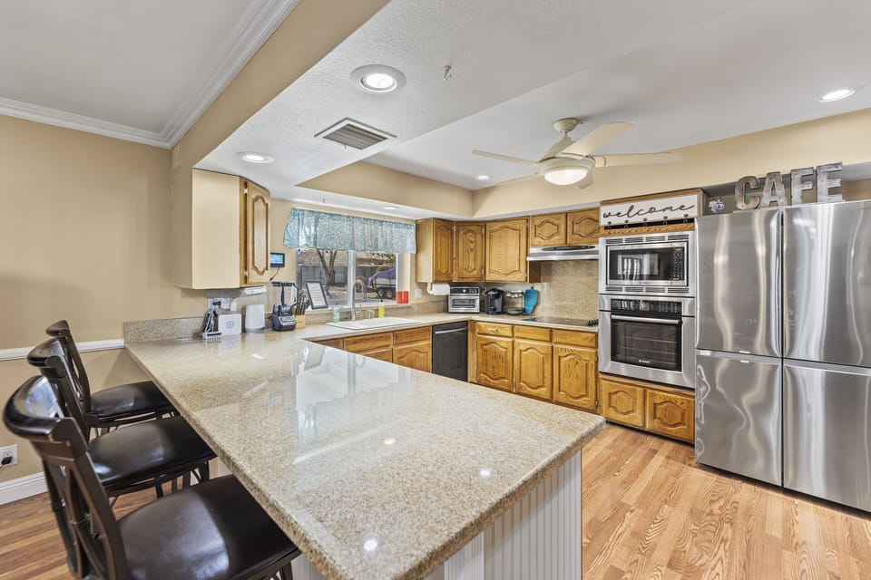 The kitchen has coffee maker, blender, toaster, pans, settings for 12+