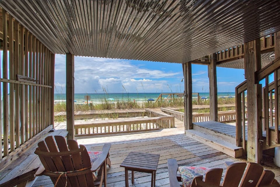 You'll love relaxing on your private deck with Adirondack chairs, watching waves roll onto pristine sand just steps away.