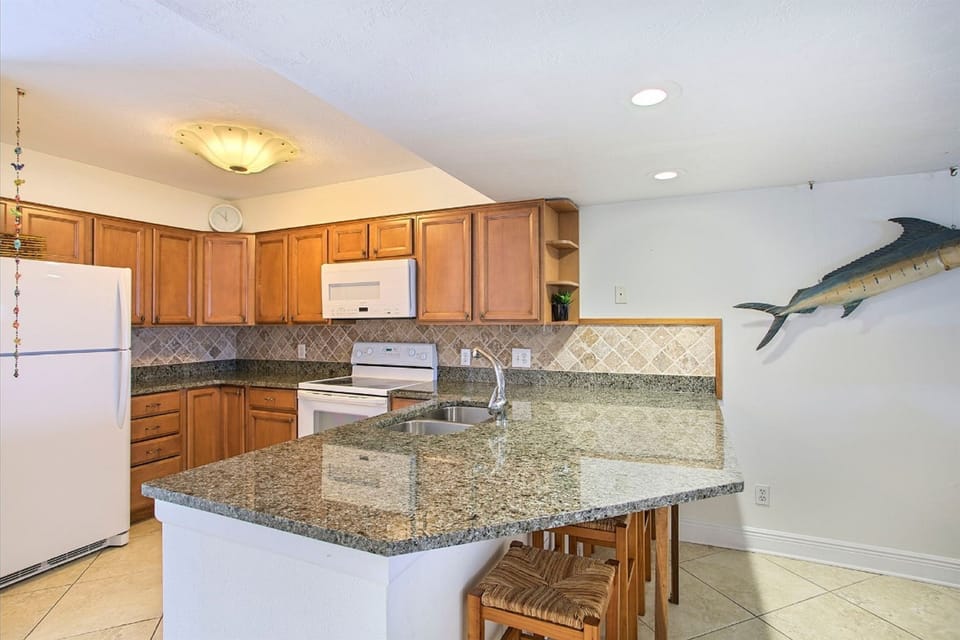 Your fully equipped kitchen awaits with granite countertops and modern appliances for memorable meals together.