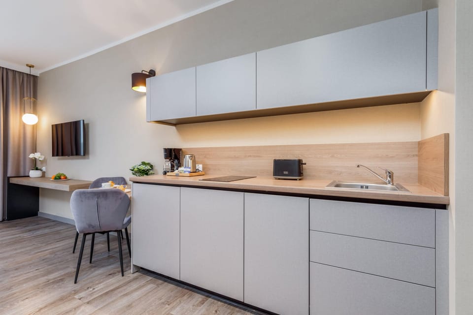 Another perspective of the kitchenette, showing its functional layout and modern lighting.
