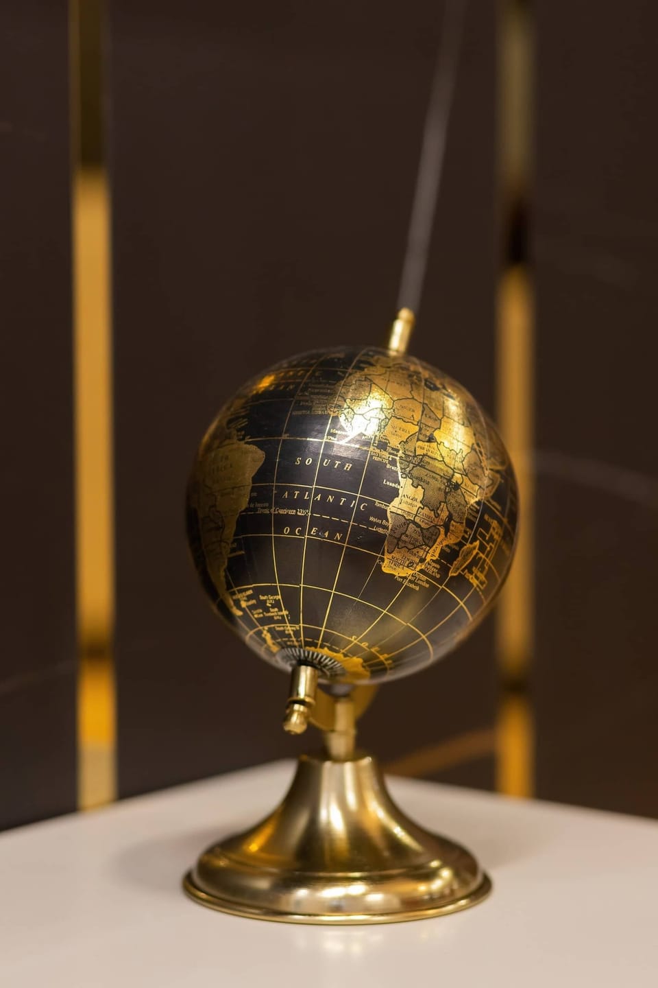A golden globe decoration, adding a classy element to the interior decor.
