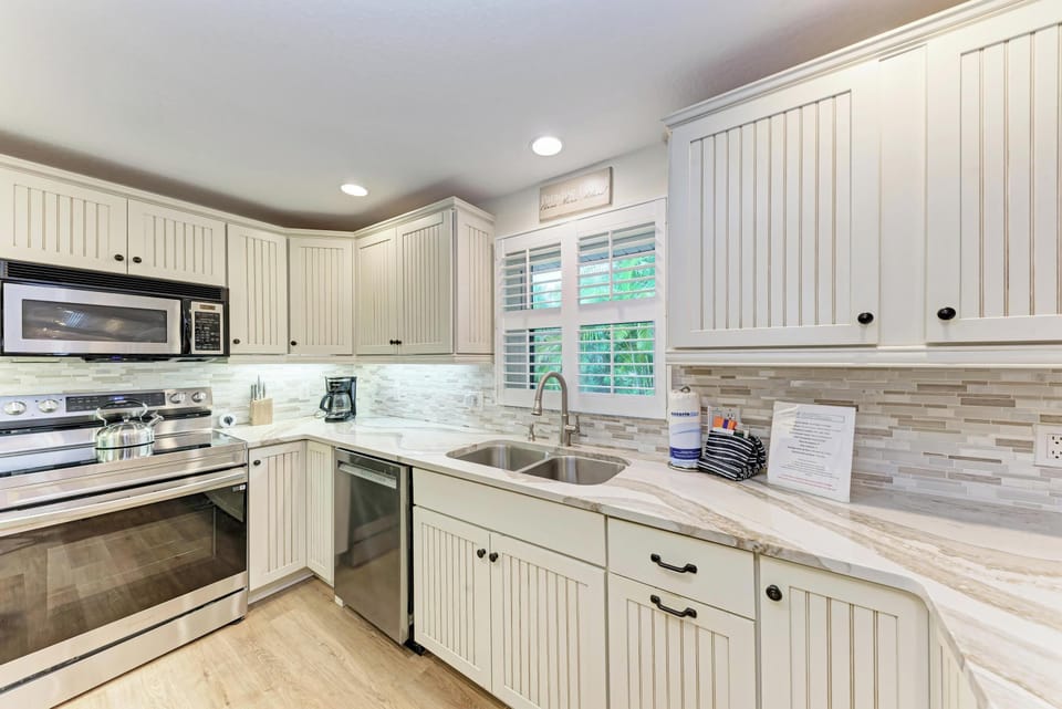 Your fully equipped kitchen features granite countertops, stainless steel appliances, and charming beadboard cabinets for effortless meal preparation.