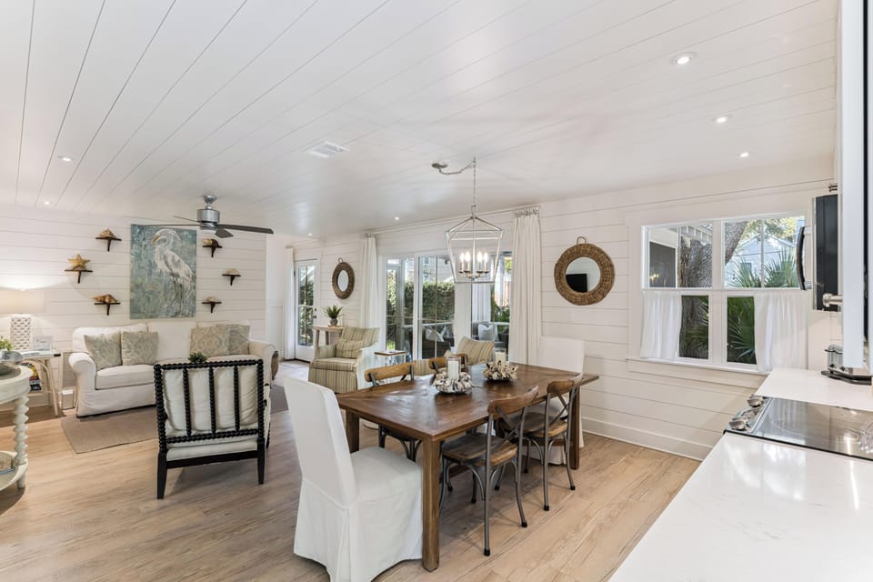 Your coastal-inspired living space blends comfort with elegance, featuring warm wood floors and charming shiplap walls perfect for gathering.