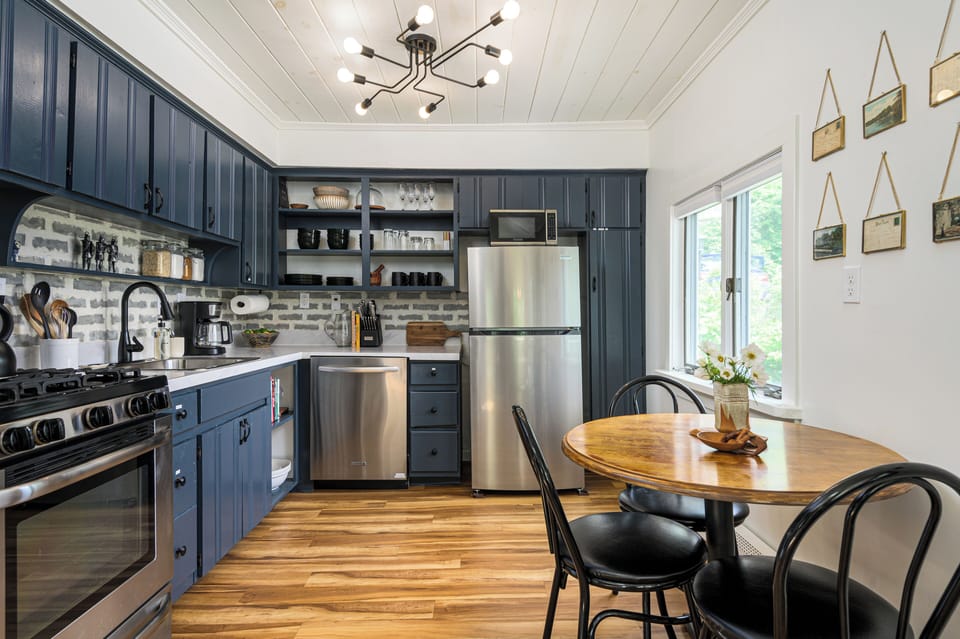 Whip up something simple or special in this light-filled kitchen, stocked with essentials and cozy seating for four (additional 4th chair available)